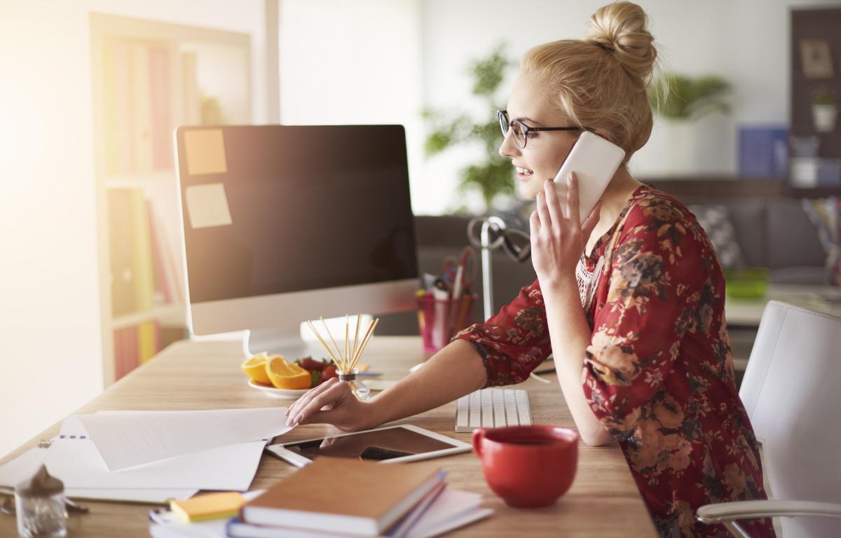 Employee experience with a woman on a laptop and on her phone