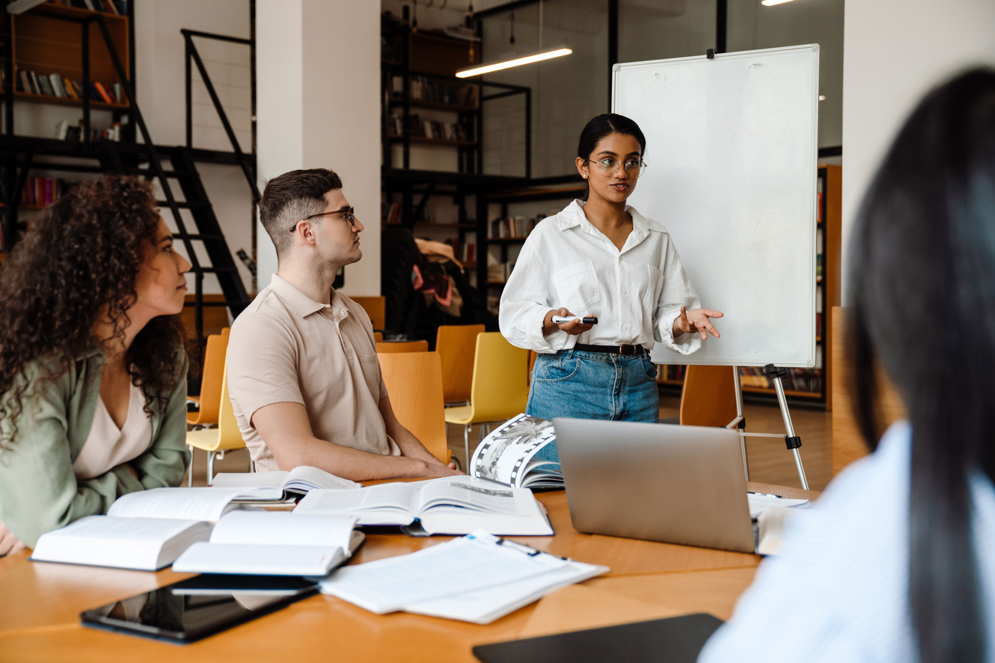 Employees around a table working on a Modern Intranet